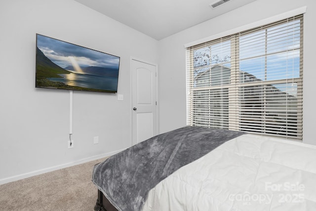 carpeted bedroom featuring baseboards