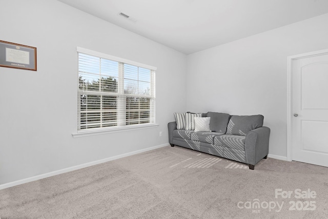 carpeted living room with visible vents and baseboards