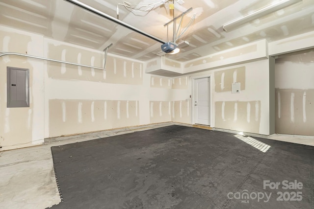 garage featuring electric panel and a garage door opener