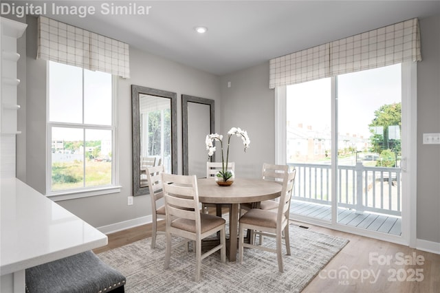 dining area with recessed lighting, light wood-style flooring, and baseboards