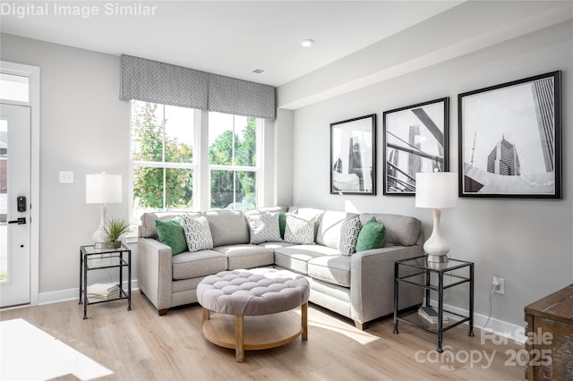 living room featuring light wood-style flooring and baseboards