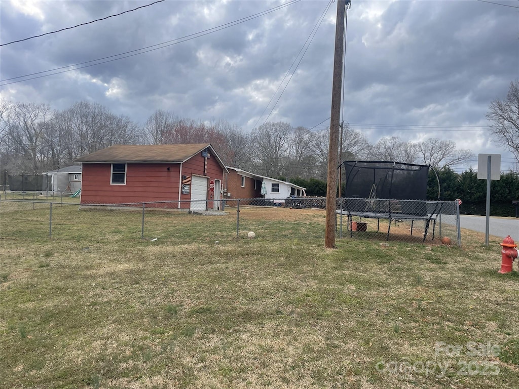 view of yard with a garage and fence