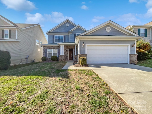 craftsman-style house with a garage, driveway, and a front lawn