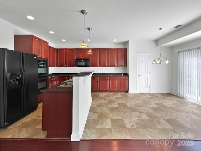 kitchen with visible vents, dark brown cabinets, black appliances, dark countertops, and decorative light fixtures