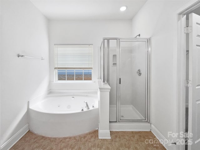 bathroom with a whirlpool tub, a stall shower, and baseboards