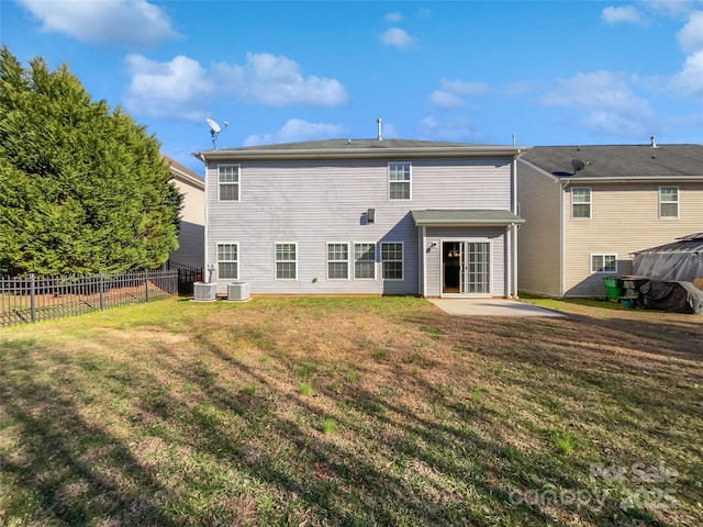 rear view of property with central AC, fence, a lawn, and a patio