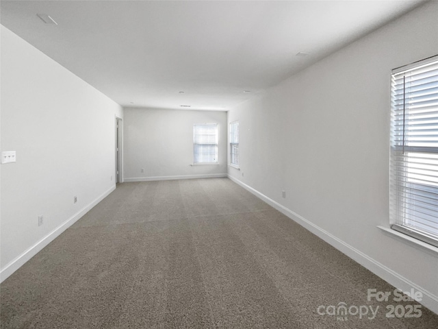 spare room with carpet floors and baseboards