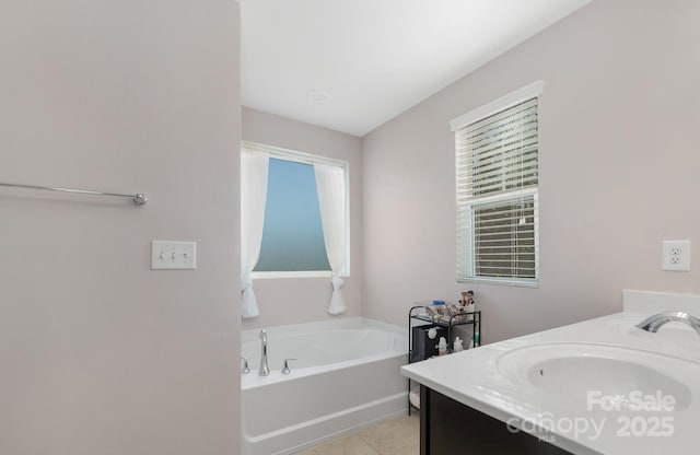 full bathroom with tile patterned flooring, a bath, and vanity