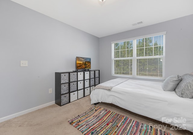 carpeted bedroom with baseboards and visible vents