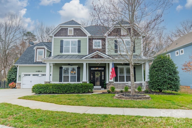 view of front of house featuring a garage, a front lawn, a porch, and concrete driveway