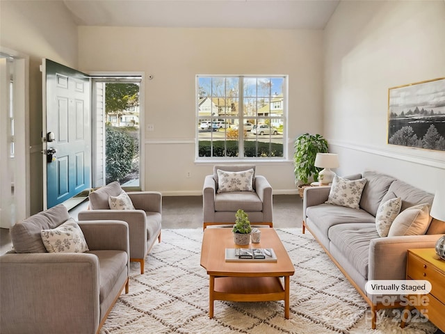 carpeted living area with baseboards