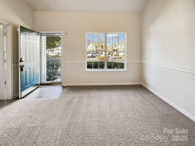 interior space with baseboards and carpet flooring