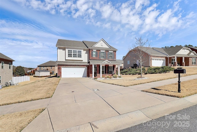 view of front of home featuring a garage, fence, concrete driveway, and brick siding