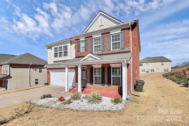 view of front of home with a garage, driveway, brick siding, and a porch