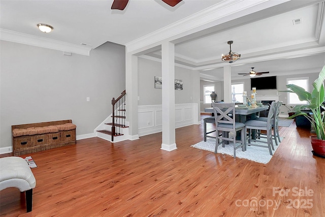 dining room featuring light wood-style floors, ceiling fan, stairs, and visible vents