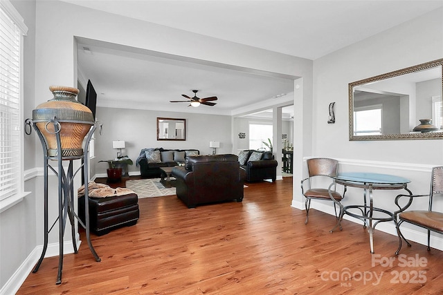 living room featuring wood finished floors and baseboards