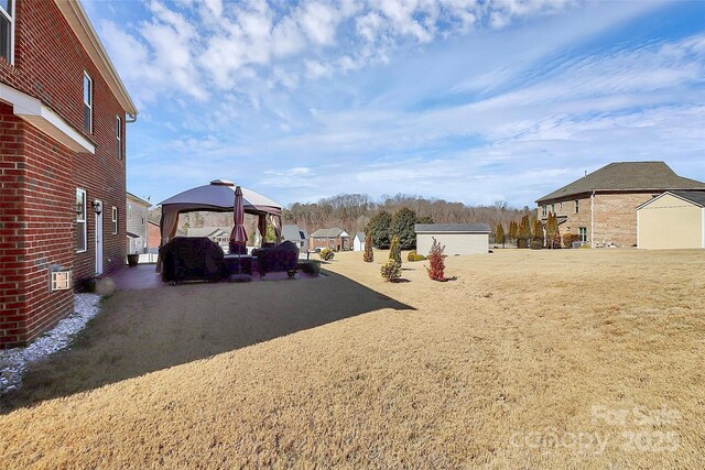 view of yard featuring a gazebo and an outdoor structure