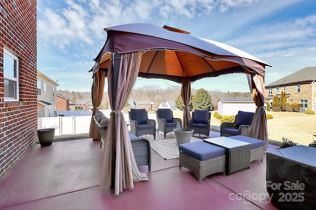 view of patio / terrace with a residential view, an outdoor living space, and a gazebo