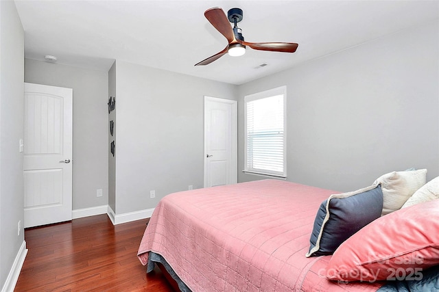 bedroom with visible vents, ceiling fan, baseboards, and wood finished floors