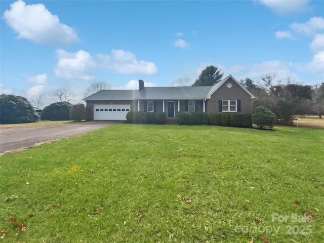 single story home with an attached garage, brick siding, aphalt driveway, and a front yard