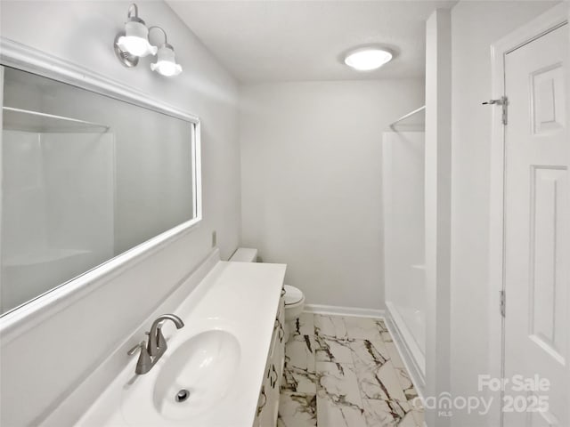 full bathroom with toilet, vanity, baseboards, marble finish floor, and a shower