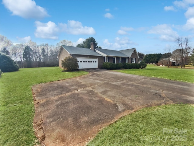 single story home with driveway, a front lawn, a chimney, and an attached garage