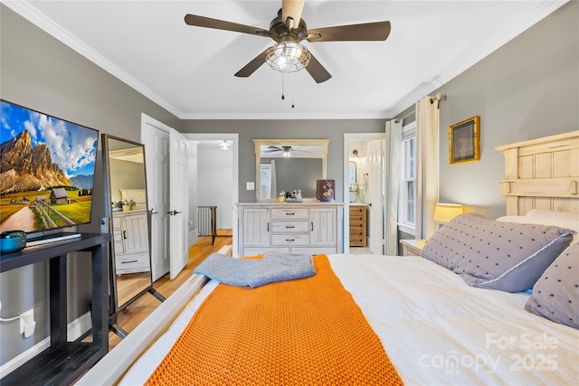 bedroom featuring ceiling fan, ornamental molding, ensuite bath, and light wood-style floors