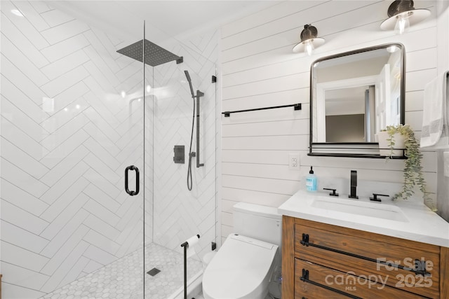 bathroom featuring toilet, wood walls, a shower stall, and vanity