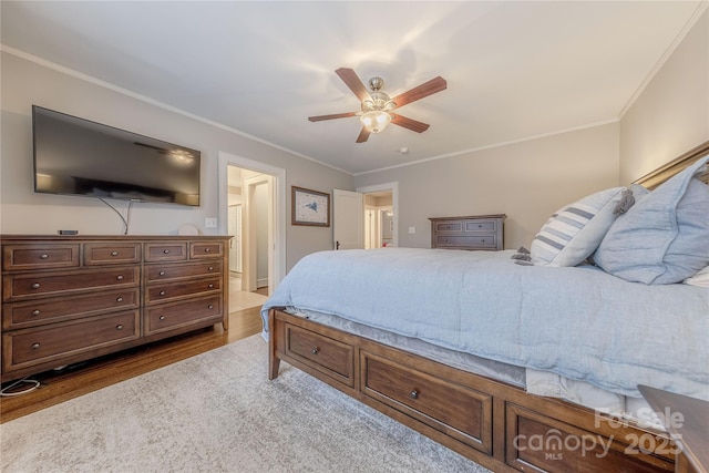 bedroom featuring ornamental molding, ceiling fan, and wood finished floors