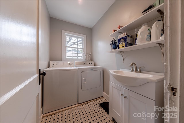 washroom with a sink, cabinet space, and washing machine and dryer