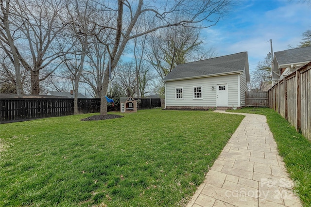 view of yard featuring an outbuilding and a fenced backyard