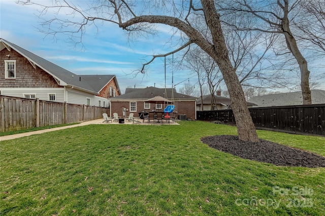 view of yard with a patio, central AC, and a fenced backyard