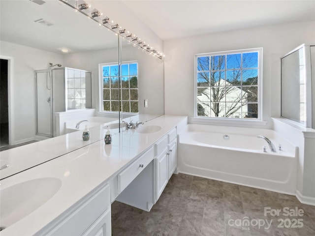 full bath with a garden tub, double vanity, a stall shower, and a sink