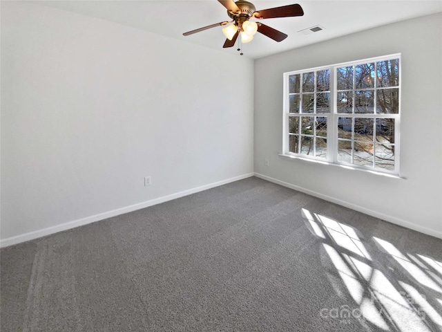 unfurnished room featuring baseboards, visible vents, dark colored carpet, and a ceiling fan