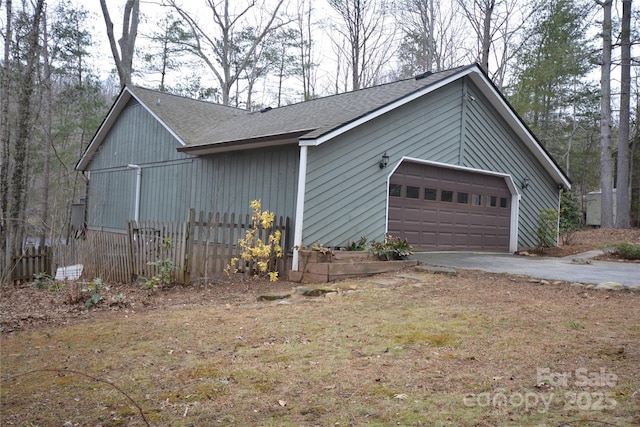 view of side of home featuring a detached garage