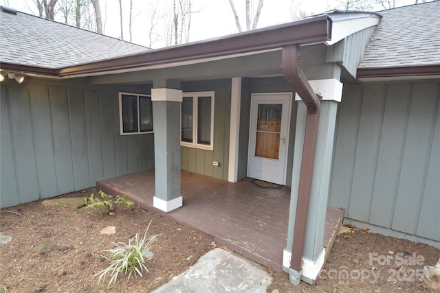 entrance to property featuring a shingled roof and board and batten siding