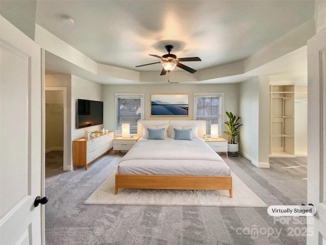 bedroom with ceiling fan, baseboards, and carpet flooring