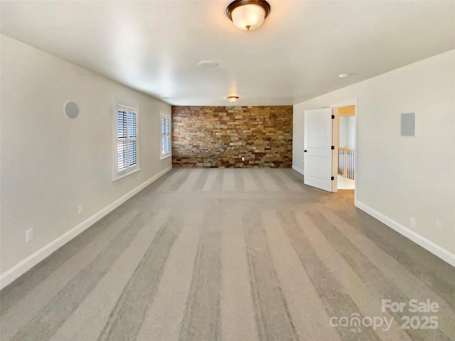 unfurnished living room with baseboards