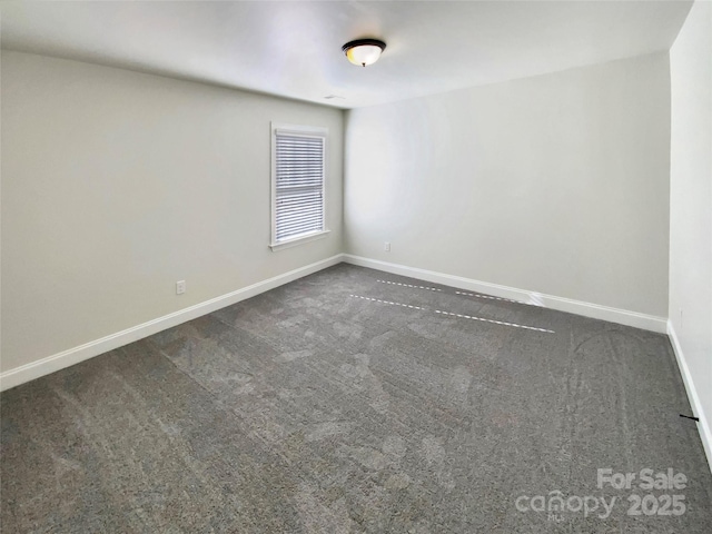 empty room with carpet and baseboards