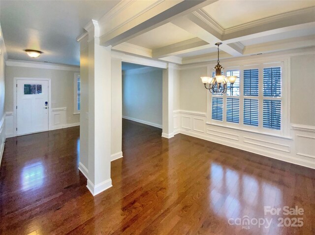 unfurnished dining area featuring a chandelier, dark wood-style flooring, and crown molding