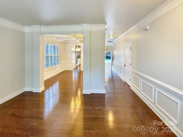 unfurnished room with dark wood-style floors, a notable chandelier, a decorative wall, and coffered ceiling