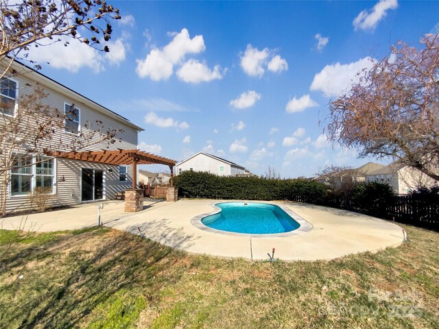 view of pool with a fenced in pool, a lawn, a patio area, fence, and a pergola