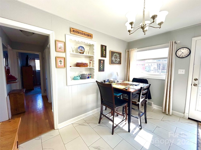 dining space featuring visible vents, baseboards, and a notable chandelier