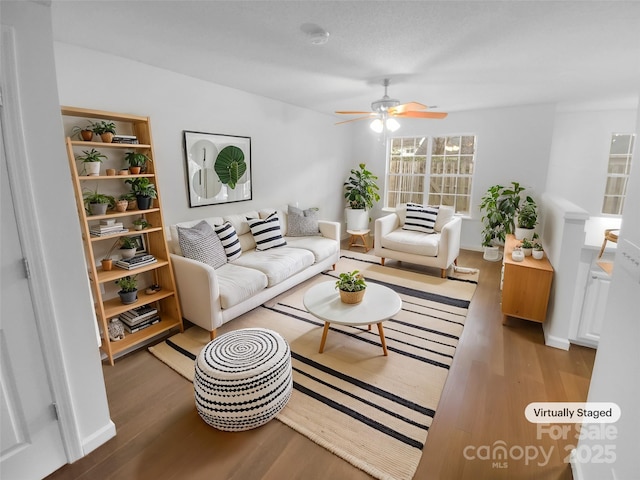 living room featuring ceiling fan and wood finished floors