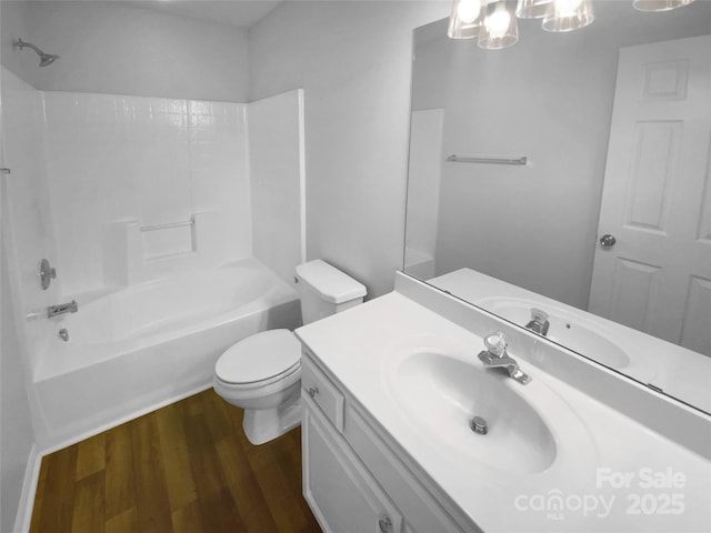 full bathroom with vanity, shower / bath combination, wood finished floors, and toilet