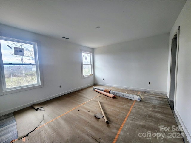 spare room featuring baseboards