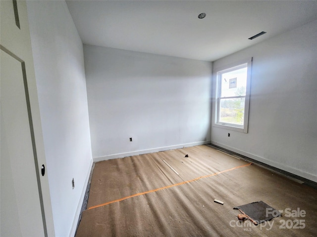 spare room with visible vents and baseboards