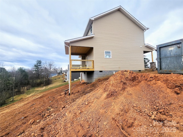 view of side of property with crawl space