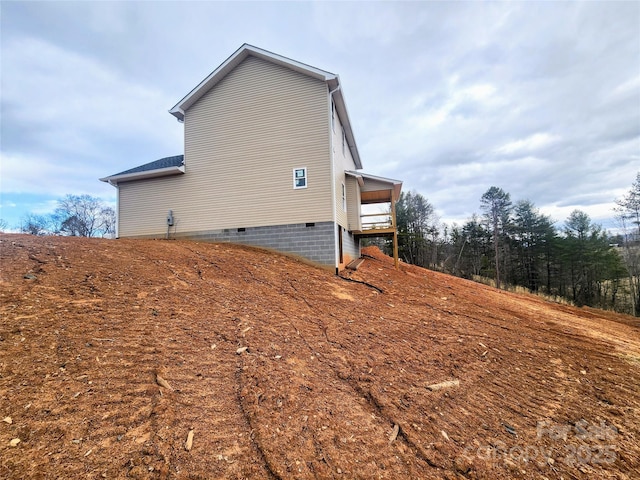 view of side of property with crawl space