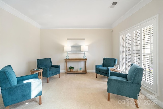 sitting room featuring a wealth of natural light, visible vents, and ornamental molding